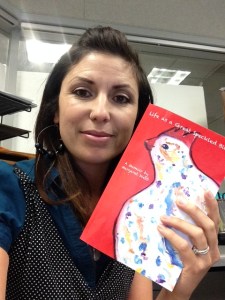 Theresa Hemsath holds the copy of the memoir Life as a Speckled Bird